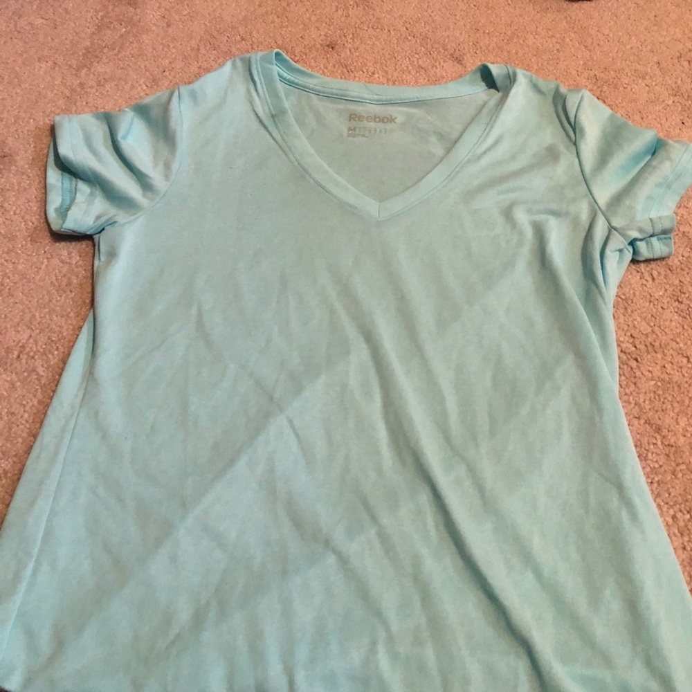 Baby blue reebok sport material shirt